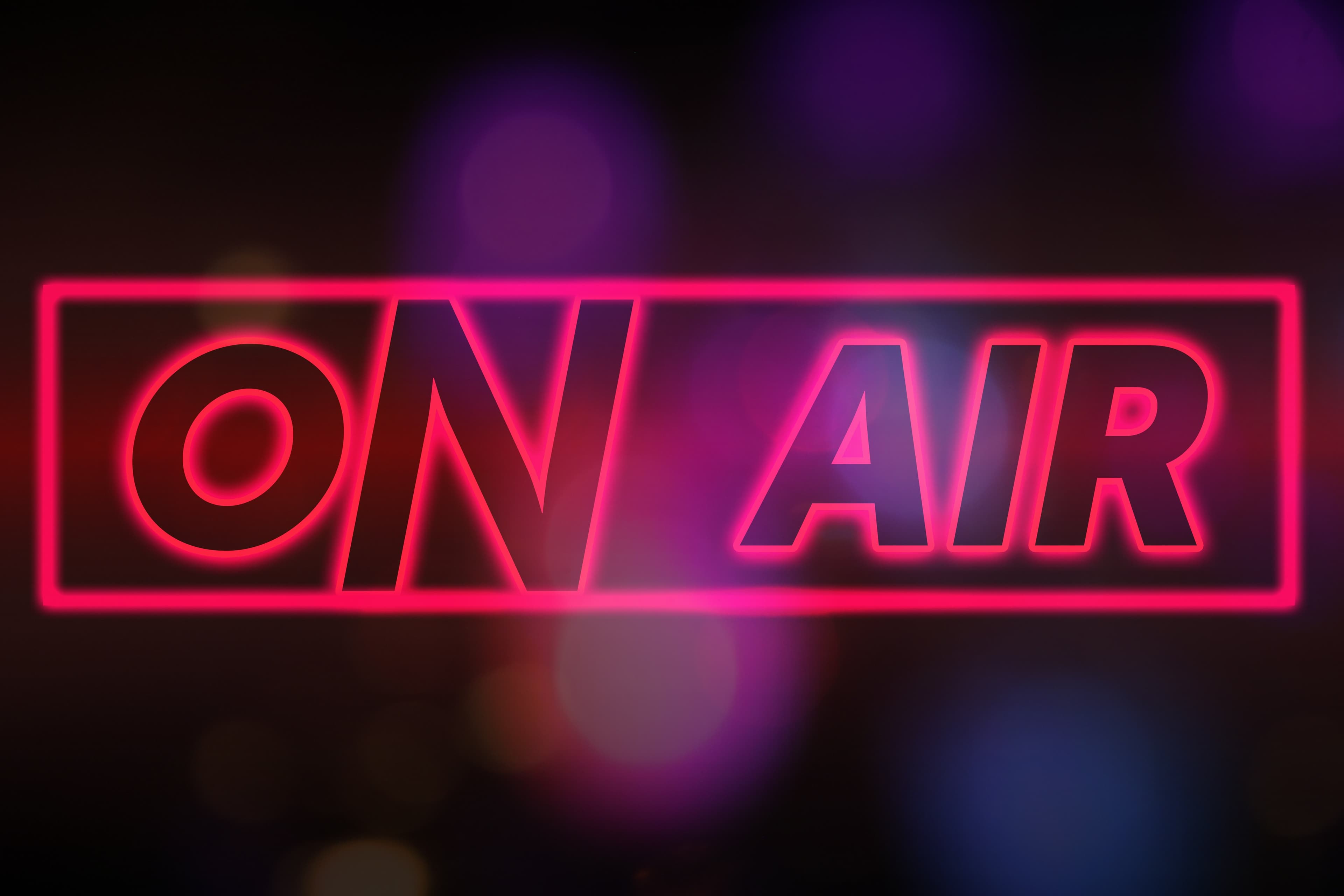 Neon ON AIR sign glowing in a studio